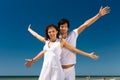 Couple enjoying freedom on the beach