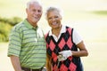 Couple Enjoying A Game Of Golf Royalty Free Stock Photo