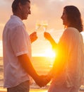 Couple Enjoying Glass of Champene on the Beach at Sunset