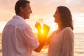 Couple Enjoying Glass of Champene on the Beach at Sunset