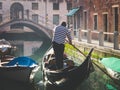 Couple enjoying gondola tour in the water channel of Venice