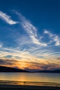 Couple enjoying gorgeous sunset on the beach. Royalty Free Stock Photo