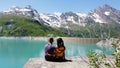 Couple enjoying the greenery waterscape and mountains in Kaprun Austria