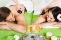 Couple Enjoying Hot Stone Massage At Spa Royalty Free Stock Photo