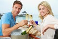 Couple Enjoying Meal In Seafront Restaurant