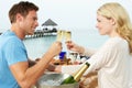 Couple Enjoying Meal In Seafront Restaurant