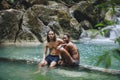 Couple enjoying a natural waterfall