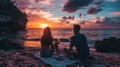 Couple enjoying a picnic on the beach at sunset Royalty Free Stock Photo