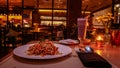 A couple enjoying romantic candle light dinner with aglio olio on the table Royalty Free Stock Photo