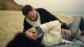 Couple enjoying romantic date at beach. Joyful people flirting together by sea. Royalty Free Stock Photo