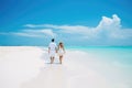 A couple enjoying a romantic stroll on the beach, holding hands and taking in the beautiful surroundings, young couple walking on