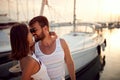 Couple enjoying by the sea.Woman kissing man on dock during sunset Royalty Free Stock Photo