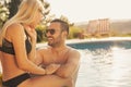 Couple enjoying summer day by the swimming pool Royalty Free Stock Photo