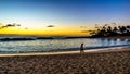 Couple enjoying the Sunset over the lagoon and beach under blue sky on the West Coast of Oahu