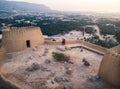 Couple enjoying sunset view from Dhayah fort in the UAE