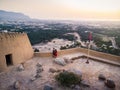 Couple enjoying sunset view from Dhayah fort in the UAE