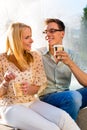 Couple enjoying take away coffee in a break Royalty Free Stock Photo