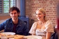 Couple Enjoying Takeaway Meal At Home Together With Friends Royalty Free Stock Photo