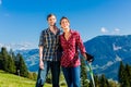 Couple enjoying view hiking in the alpine mountains Royalty Free Stock Photo