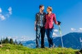 Couple enjoying view hiking in the alpine mountains Royalty Free Stock Photo