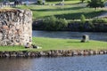 People having a picnic by the ruins of the Kajaani castle in Finland