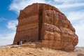 Couple entering a Nabatean tomb in MadaÃÂ®n Saleh archeological s