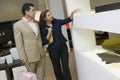 Couple Examining Glass Bowl In Furniture Shop