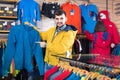 Couple examining track jackets in sports clothes store Royalty Free Stock Photo