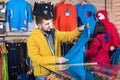 Couple examining track jackets in sports clothes store Royalty Free Stock Photo