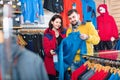 Couple examining track jackets in sports clothes store Royalty Free Stock Photo