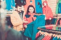Couple examining track jackets in sports clothes store Royalty Free Stock Photo