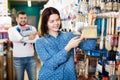 Couple examining various painting brushes Royalty Free Stock Photo