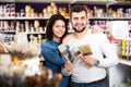 Couple examining various painting brushes Royalty Free Stock Photo