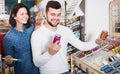 couple examining various paints in paint store Royalty Free Stock Photo