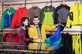 Couple examining windcheaters in store Royalty Free Stock Photo