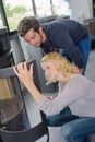 Couple examining a woodburner Royalty Free Stock Photo