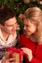 Couple Exchanging Christmas Gifts