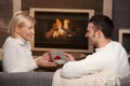 Couple exchanging gift at home