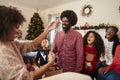 Couple Exchanging Gifts As Multi Generation Family Celebrate Christmas At Home Together Royalty Free Stock Photo