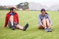 Couple, exercise and grass with stretching legs, smile and workout together for fitness in summer. People, training and Royalty Free Stock Photo