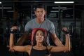 Couple exercises with dumbbells together in gym Royalty Free Stock Photo