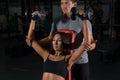 Couple exercises with dumbbells together in gym Royalty Free Stock Photo