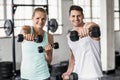 couple exercising with dumbbells in gym Royalty Free Stock Photo