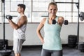 couple exercising with dumbbells in gym Royalty Free Stock Photo