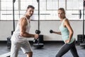 Couple exercising with dumbbells in gym Royalty Free Stock Photo