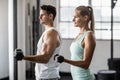 couple exercising with dumbbells in gym Royalty Free Stock Photo