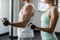 couple exercising with dumbbells in gym Royalty Free Stock Photo