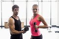 Couple exercising with dumbbells in gym Royalty Free Stock Photo