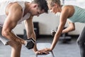 couple exercising with dumbells on a workout bench Royalty Free Stock Photo