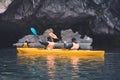 Couple exploring cave on kayak and taking photograps in the boat. Ha Long Bay, Vietnam, Cat Ba Island Royalty Free Stock Photo